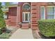 Elegant front entrance with brick steps, decorative planters, and arched window at 643 Old Greenville Rd, Fayetteville, GA 30215