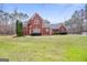 Beautiful brick home featuring manicured lawn and mature trees at 643 Old Greenville Rd, Fayetteville, GA 30215