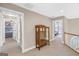 Upstairs hallway features neutral carpet, cabinet, and views of bedrooms and cathedral ceiling at 643 Old Greenville Rd, Fayetteville, GA 30215