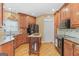 Spacious kitchen featuring wooden cabinetry, an island, granite countertops, and black appliances at 643 Old Greenville Rd, Fayetteville, GA 30215