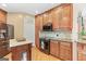 Kitchen with wood cabinets, an island, granite countertops, and stainless steel appliances at 643 Old Greenville Rd, Fayetteville, GA 30215