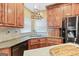 Well-equipped kitchen with wood cabinets, granite countertops, stainless steel appliances, and sink at 643 Old Greenville Rd, Fayetteville, GA 30215