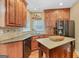 Kitchen featuring wood cabinetry, granite countertops, stainless steel appliances, and tile backsplash at 643 Old Greenville Rd, Fayetteville, GA 30215