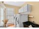 Well-lit laundry room with washer, dryer, storage cabinets, utility sink and window at 643 Old Greenville Rd, Fayetteville, GA 30215