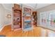 Inviting living room with hardwood floors, fireplace and built-in shelving for storage and décor at 643 Old Greenville Rd, Fayetteville, GA 30215