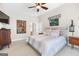 Large main bedroom with plush carpet, ceiling fan, and picture frame decor at 643 Old Greenville Rd, Fayetteville, GA 30215