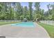 Inviting in-ground pool with surrounding patio and white picket fence in a backyard oasis at 643 Old Greenville Rd, Fayetteville, GA 30215