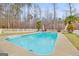 Inviting pool with lounge area surrounded by a white fence and lush trees at 643 Old Greenville Rd, Fayetteville, GA 30215
