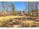 View of backyard featuring lawn, trees and the rear exterior of home with deck and stairs at 300 Tarragon Dr, Fayetteville, GA 30215