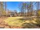 Expansive backyard features lush lawn, mature trees, and tiered deck perfect for outdoor entertaining at 300 Tarragon Dr, Fayetteville, GA 30215