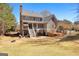 View of backyard featuring lawn, trees and the rear exterior of home with deck and stairs at 300 Tarragon Dr, Fayetteville, GA 30215