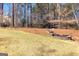 Picturesque backyard with stone water feature and mature trees providing a serene environment at 300 Tarragon Dr, Fayetteville, GA 30215