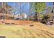 Spacious backyard with mature trees, fire pit and stone water feature at 300 Tarragon Dr, Fayetteville, GA 30215