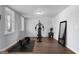 Home gym setup with exercise machine, free weights, mirror, and plank flooring at 300 Tarragon Dr, Fayetteville, GA 30215