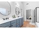 Bright bathroom featuring a dual sink vanity with sleek fixtures and tile flooring at 300 Tarragon Dr, Fayetteville, GA 30215
