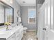 Bathroom featuring a dual sink vanity, toilet, and shower at 300 Tarragon Dr, Fayetteville, GA 30215