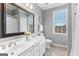 Bright bathroom featuring a dual sink vanity, and neutral-colored walls at 300 Tarragon Dr, Fayetteville, GA 30215