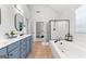 Bright bathroom with a walk-in shower, soaking tub, double sink vanity, and neutral colors at 300 Tarragon Dr, Fayetteville, GA 30215