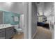 Bathroom and bedroom with a tub/shower combo, vanity with sink, and modern fixtures at 300 Tarragon Dr, Fayetteville, GA 30215
