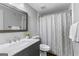 Cozy bathroom featuring a decorative mirror, tile floors, and modern fixtures at 300 Tarragon Dr, Fayetteville, GA 30215