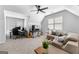 Bonus room featuring a large sectional, desk, ceiling fan and plenty of natural light at 300 Tarragon Dr, Fayetteville, GA 30215