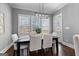 Bright dining area with modern light fixture, large windows, and access to outdoor deck at 300 Tarragon Dr, Fayetteville, GA 30215