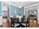 Sophisticated dining room with wainscoting, stylish wallpaper, and modern lighting fixture at 300 Tarragon Dr, Fayetteville, GA 30215
