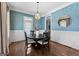 Elegant dining room with stylish wallpaper, modern lighting and an open view to the backyard at 300 Tarragon Dr, Fayetteville, GA 30215