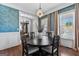 Elegant dining room with decorative wallpaper, modern chandelier, and natural light at 300 Tarragon Dr, Fayetteville, GA 30215