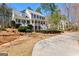 Beautiful two-story home with a double porch, gray exterior, and well-manicured lawn at 300 Tarragon Dr, Fayetteville, GA 30215