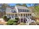 Stately two-story home boasting a welcoming double porch, gray siding, and lush landscaping at 300 Tarragon Dr, Fayetteville, GA 30215