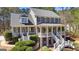 Stately two-story home boasting a welcoming double porch, gray siding, and lush landscaping at 300 Tarragon Dr, Fayetteville, GA 30215