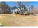 The home has a manicured lawn and landscaping with traditional exterior and covered porch at 300 Tarragon Dr, Fayetteville, GA 30215