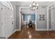 Spacious foyer boasts hardwood floors, elegant chandelier, and an open view of the adjacent dining room at 300 Tarragon Dr, Fayetteville, GA 30215