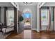 Elegant foyer features hardwood floors, arched doorway and stylish decor, creating a warm welcome at 300 Tarragon Dr, Fayetteville, GA 30215