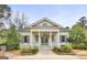 Charming single-story home featuring a welcoming front porch, classic columns, and mature landscaping at 300 Tarragon Dr, Fayetteville, GA 30215