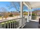 Inviting front porch with white railings, columns, and neighborhood views at 300 Tarragon Dr, Fayetteville, GA 30215