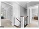Upstairs hallway featuring carpet flooring, neutral wall color, and a staircase with black iron balusters at 300 Tarragon Dr, Fayetteville, GA 30215