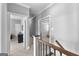 Hallway showcasing neutral paint, hardwood railings, and several doorways at 300 Tarragon Dr, Fayetteville, GA 30215