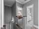 Hallway showing doors to the bathroom with white cabinets and primary bedroom with wooden furniture at 300 Tarragon Dr, Fayetteville, GA 30215