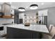 Gourmet kitchen with a large island, stainless steel appliances, white cabinets, and unique backsplash at 300 Tarragon Dr, Fayetteville, GA 30215