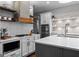 Modern kitchen featuring white cabinetry, stainless steel appliances, and quartz countertops with decorative backsplash at 300 Tarragon Dr, Fayetteville, GA 30215