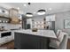 A gourmet kitchen features a large island, stainless appliances, white cabinets, and a stylish geometric backsplash at 300 Tarragon Dr, Fayetteville, GA 30215