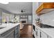 Open-concept kitchen with view to living room, brick fireplace, and hardwood floors at 300 Tarragon Dr, Fayetteville, GA 30215