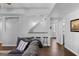 Well-lit living room with a grey sectional, bar seating, and wood floors at 300 Tarragon Dr, Fayetteville, GA 30215