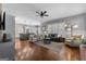 Open-concept living room with hardwood floors, a ceiling fan, and a view into the gourmet kitchen at 300 Tarragon Dr, Fayetteville, GA 30215