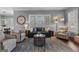Cozy living room features a leather sofa, accent chairs, and a large window for natural light at 300 Tarragon Dr, Fayetteville, GA 30215