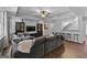 Open-concept living room with a grey sofa, tv, and bar seating at 300 Tarragon Dr, Fayetteville, GA 30215