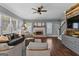 A well-lit living room with hardwood floors, fireplace, and comfortable seating, ideal for relaxation at 300 Tarragon Dr, Fayetteville, GA 30215
