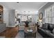An open-concept living area showcases hardwood floors and connects to a kitchen with an island at 300 Tarragon Dr, Fayetteville, GA 30215